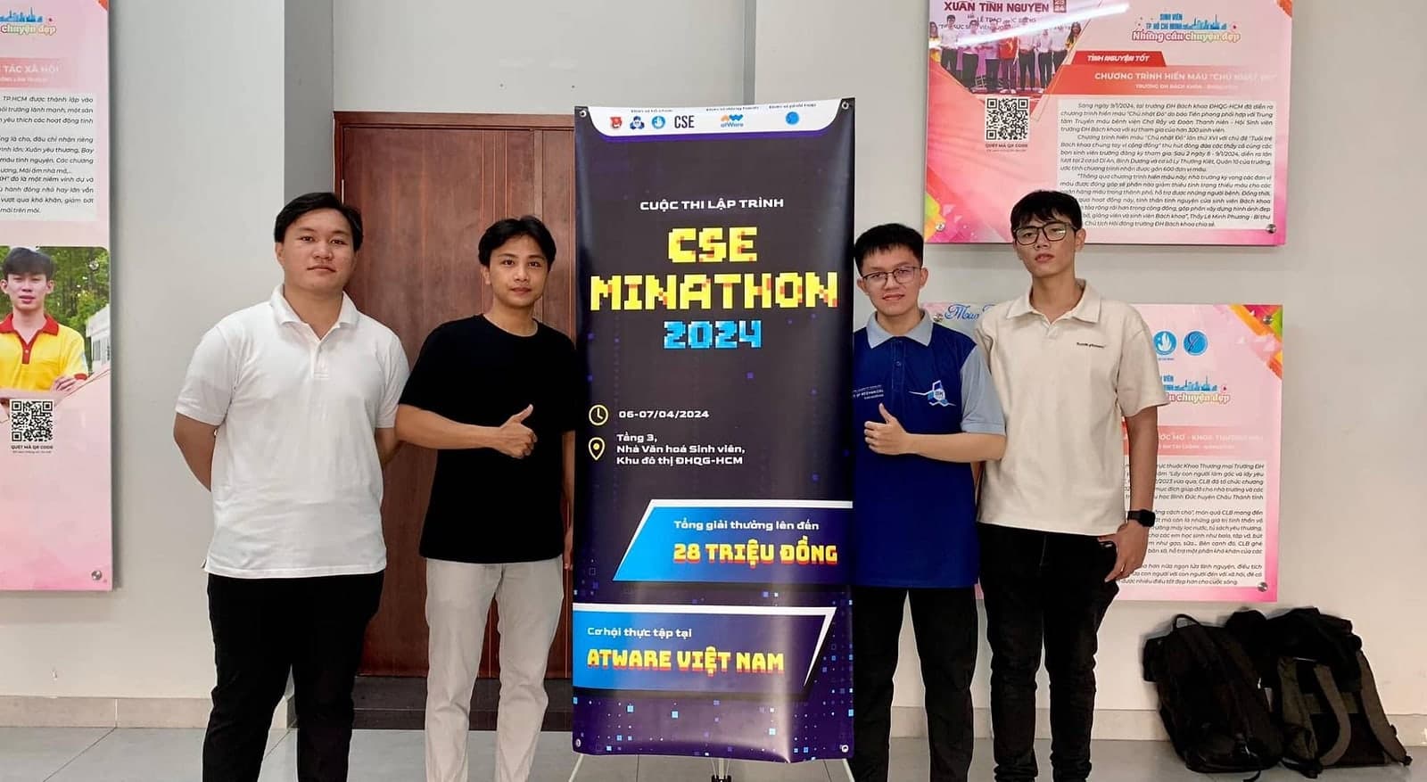Team at the CSE MINATHON 2024 programming contest beside the event banner